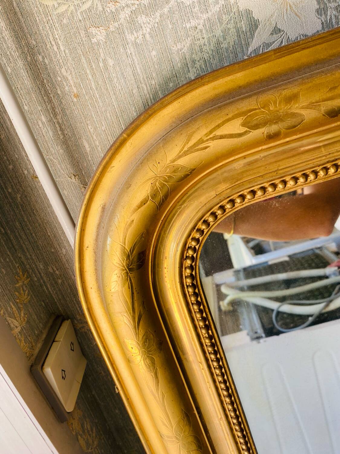 Large antique mirror with gold leaf in the Louis XV style.