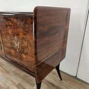 1950s mahogany sideboard with a glass top and central bar.