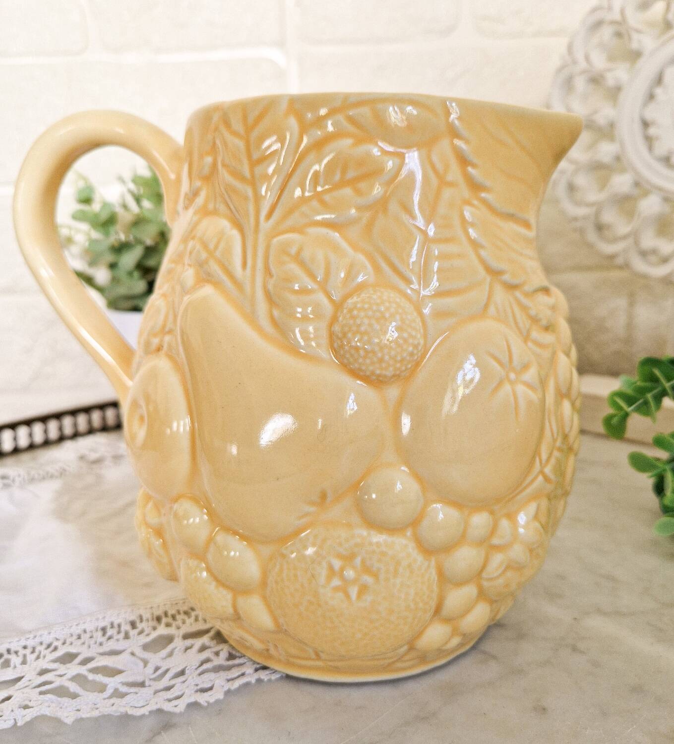 Vintage yellow pitcher in fruit slip