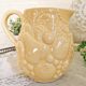 Vintage yellow pitcher in fruit slip