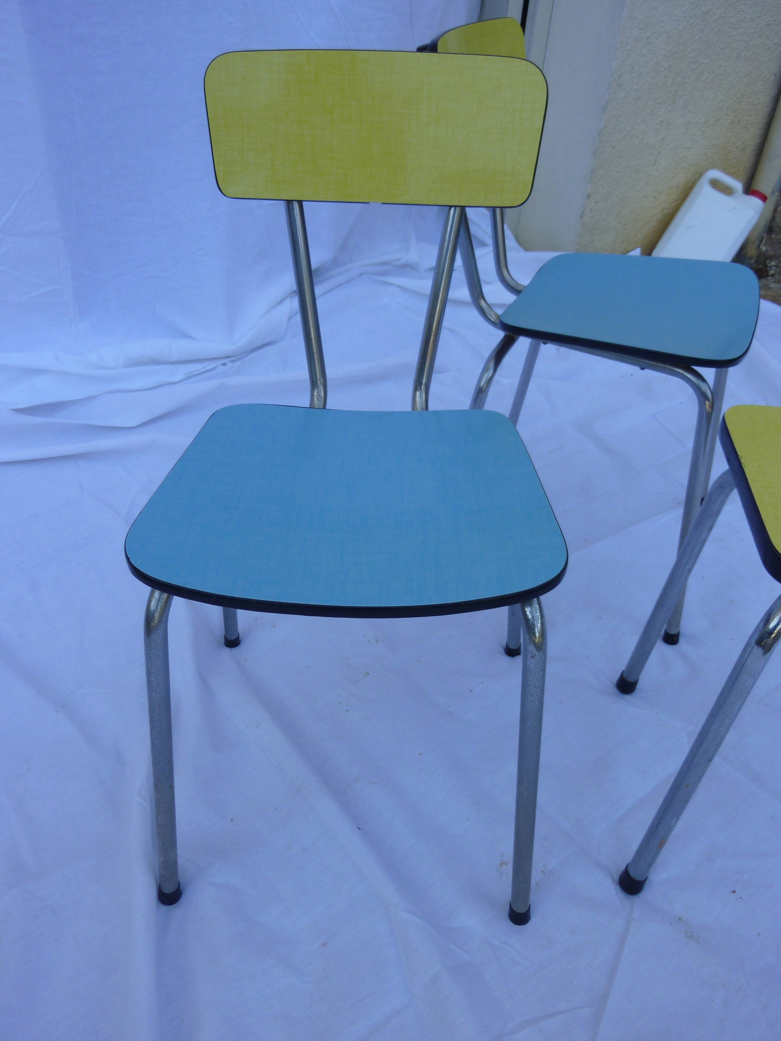 Two chairs and a yellow and blue stool in formica