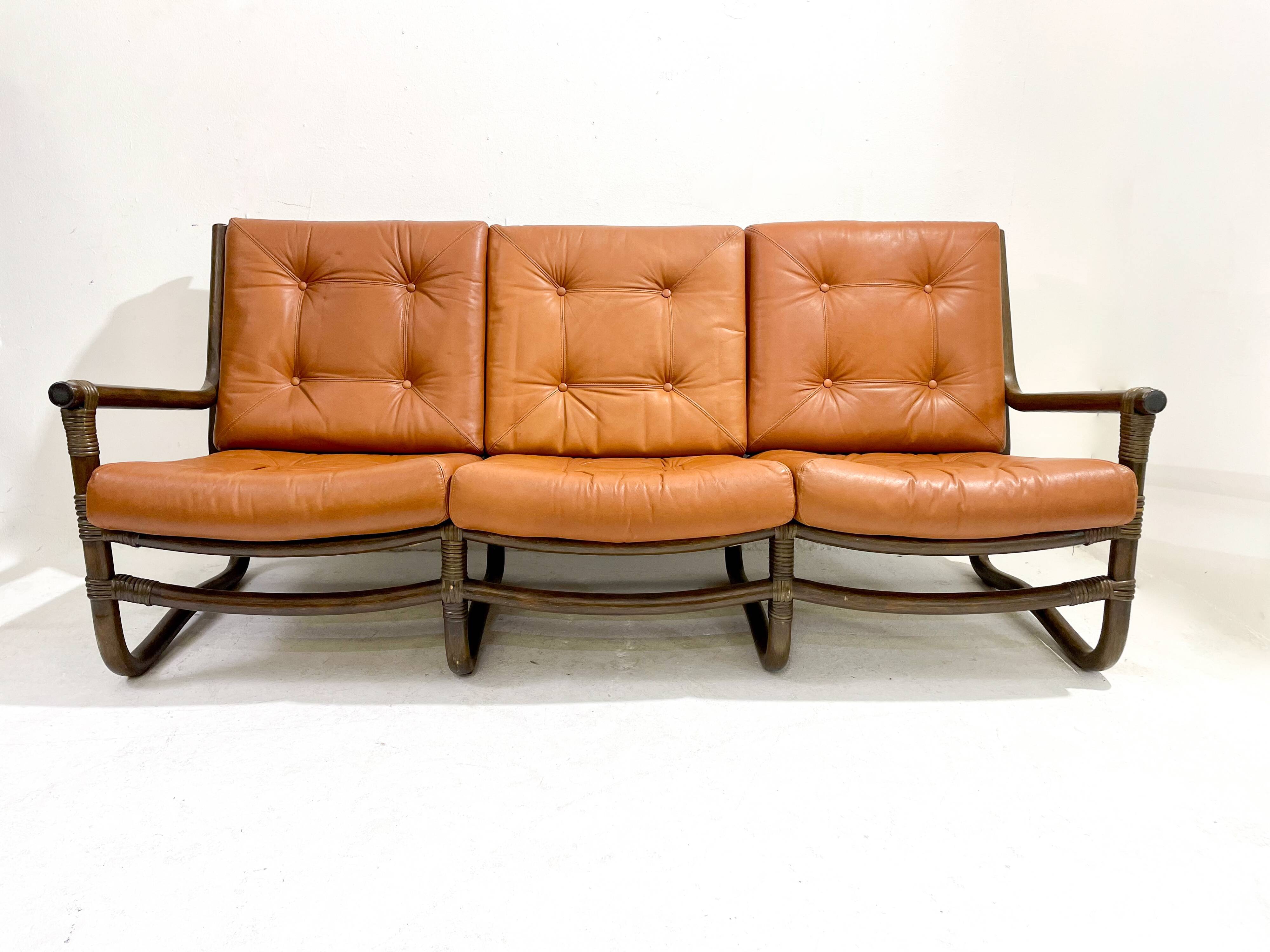 Mid-century modern rattan and cognac leather sofa
