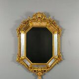 Antique octagonal mirror in richly carved gilded wood, Louis XV style.