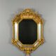 Antique octagonal mirror in richly carved gilded wood, Louis XV style.