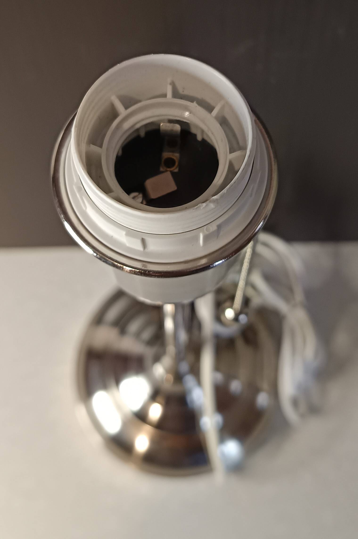 Modern white nickel lamp base with pull switch.