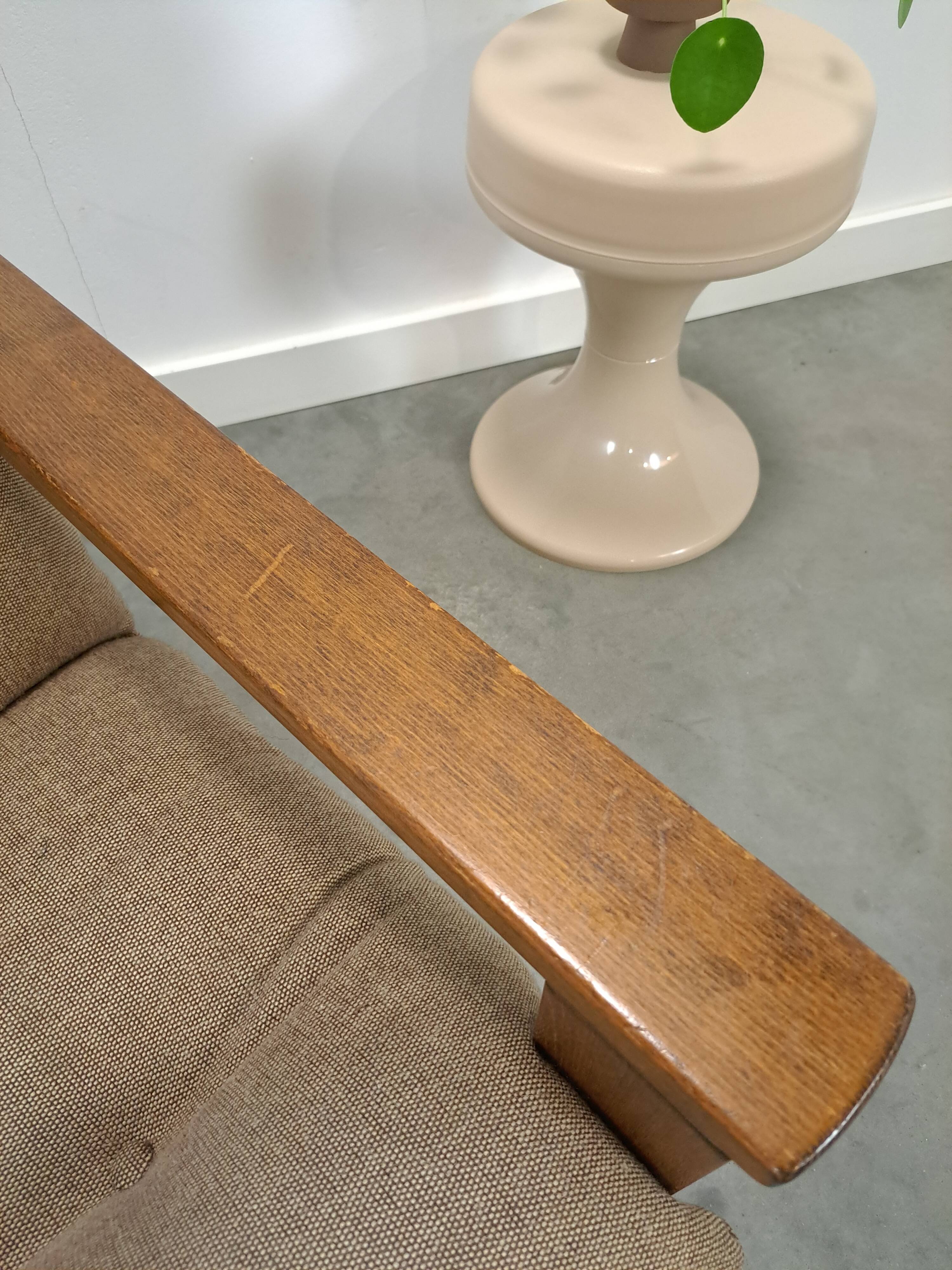 Brown-grey armchair with an oak frame.