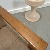 Brown-grey armchair with an oak frame.