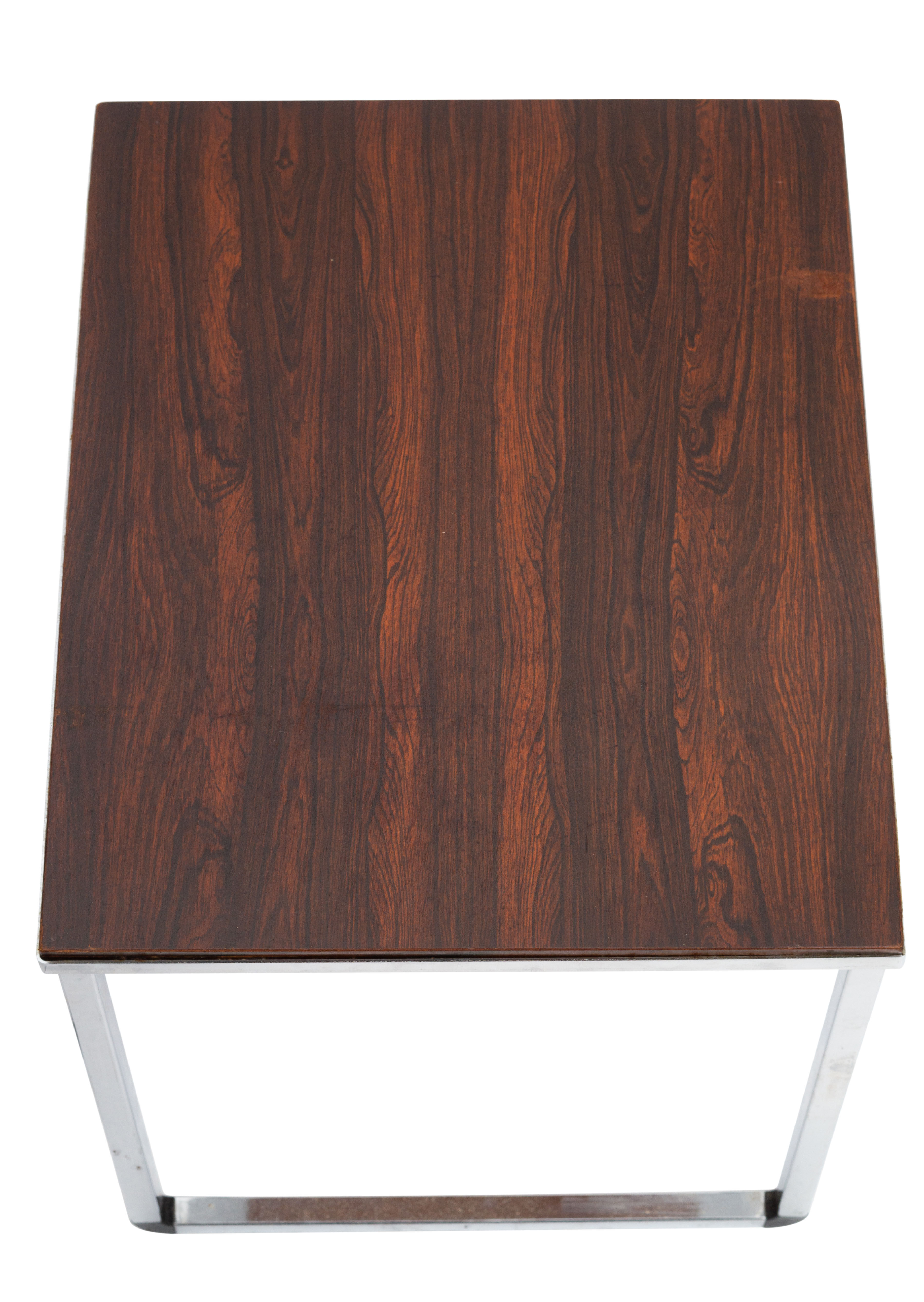 Vintage nesting table in rosewood and high polished metal base.