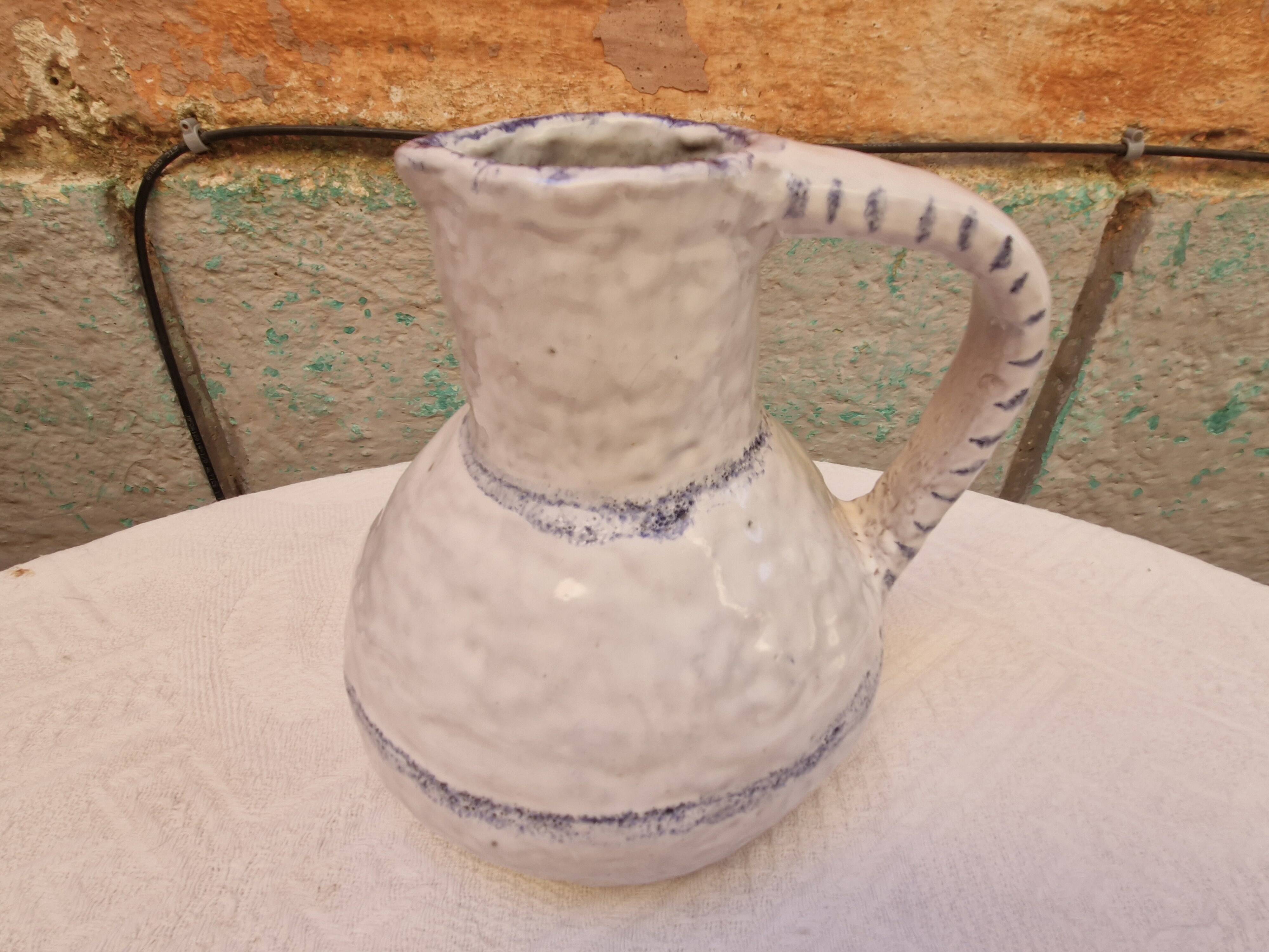 Old stamped glazed terracotta jug