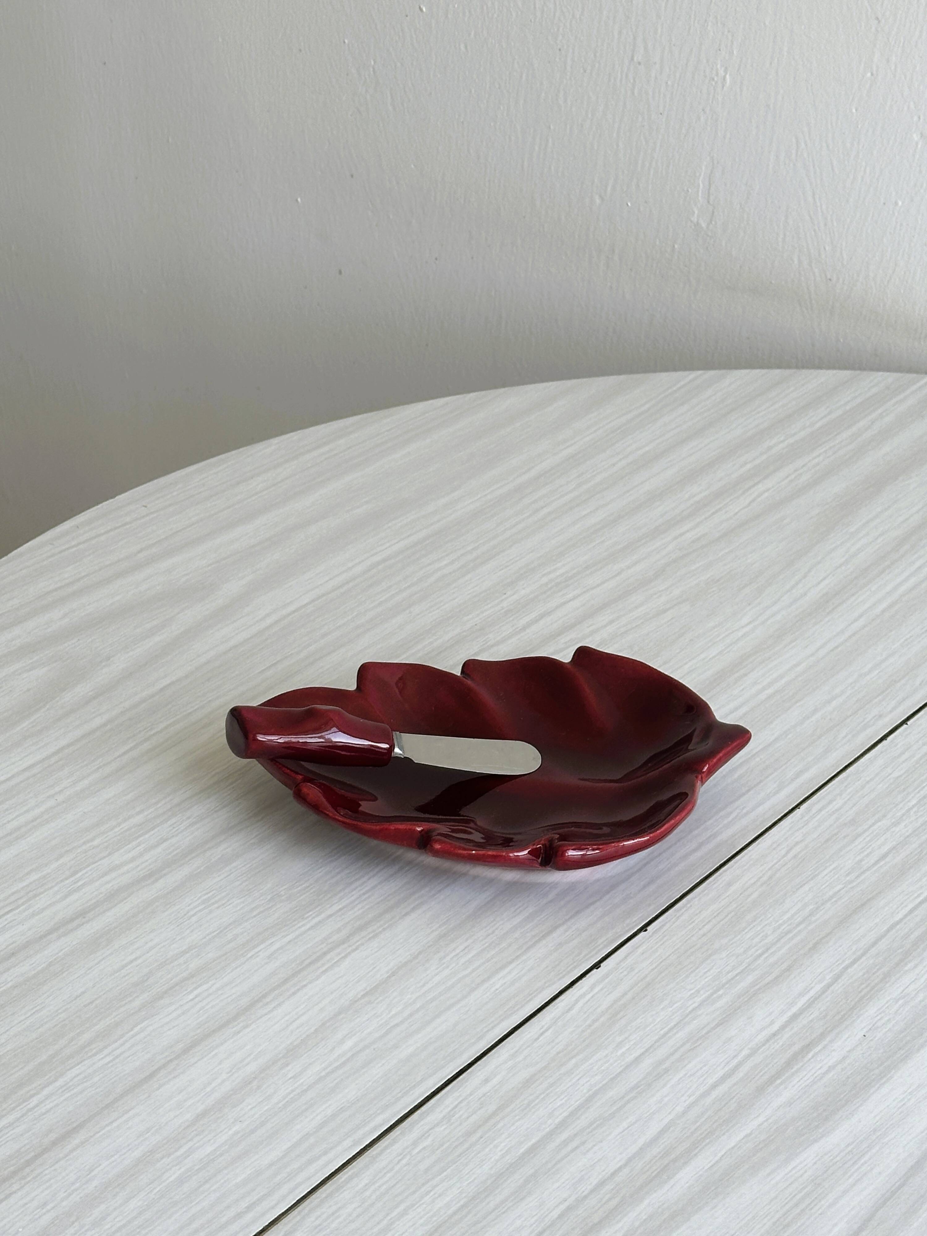 Red ceramic butter dish with knife