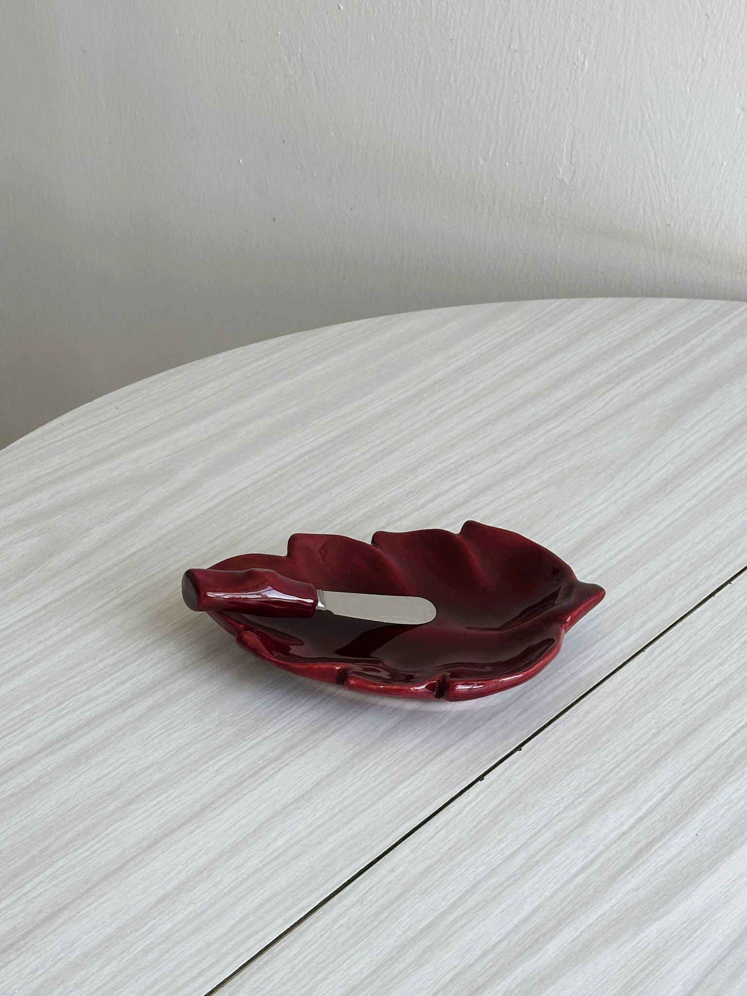 Red ceramic butter dish with knife