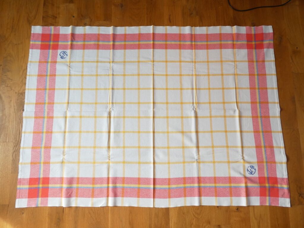 Old tablecloth and 11 towels crossed red blue