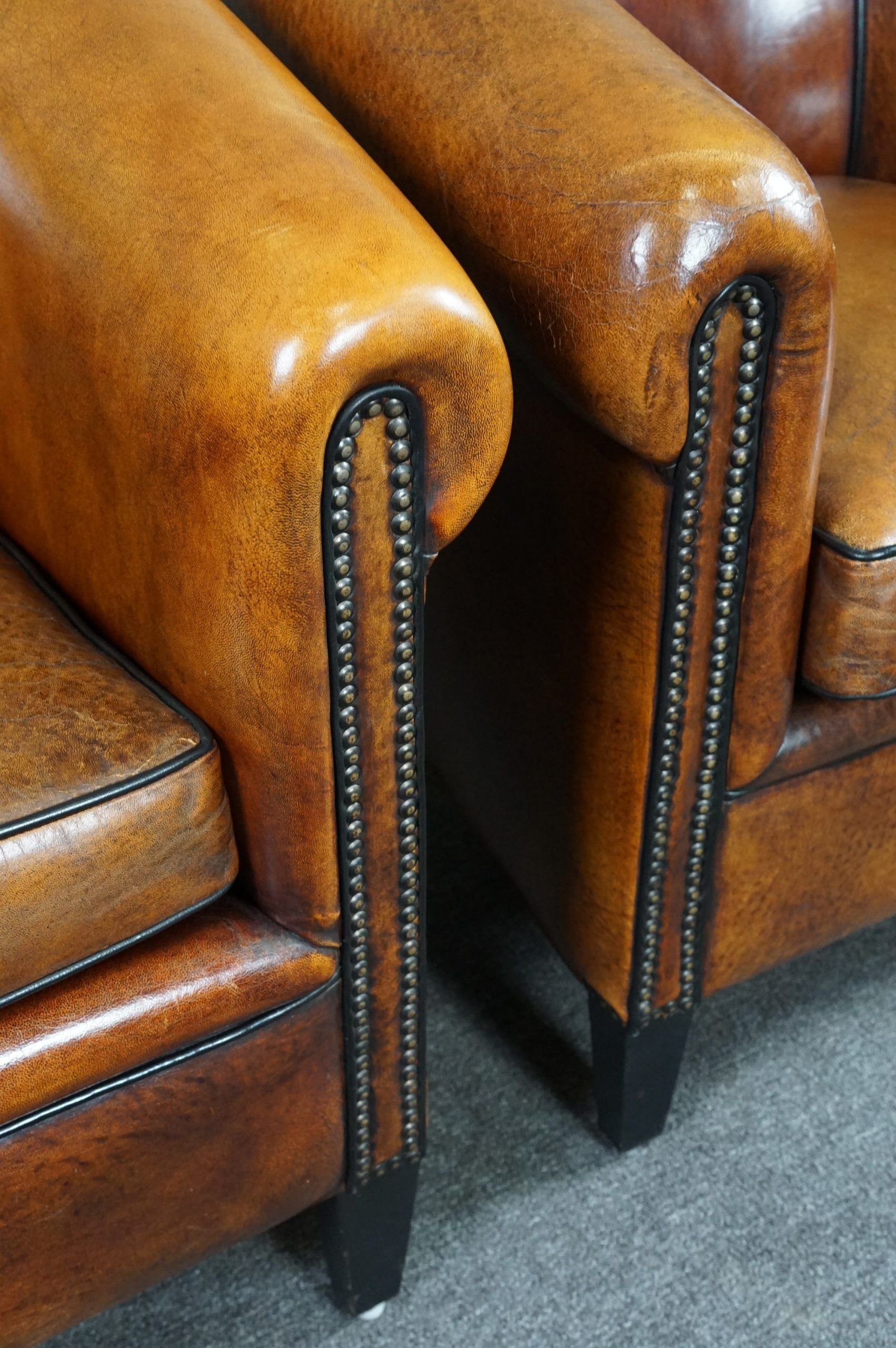 Set of 2 club chairs in black piping sheep leather