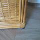 Storage column, wooden bookshelf and woven rattan.