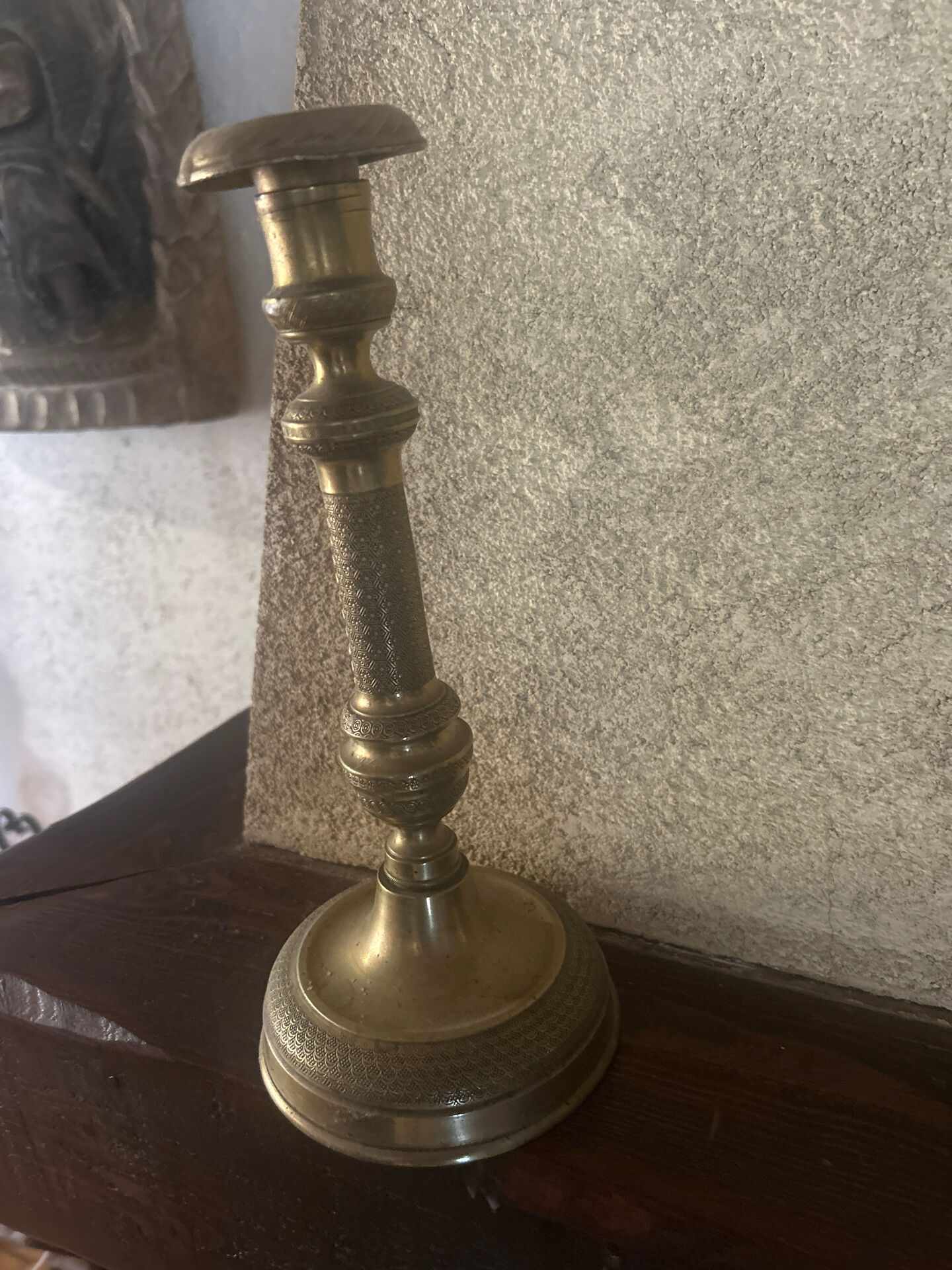 Large antique brass candlestick with floral decoration.