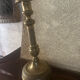 Large antique brass candlestick with floral decoration.
