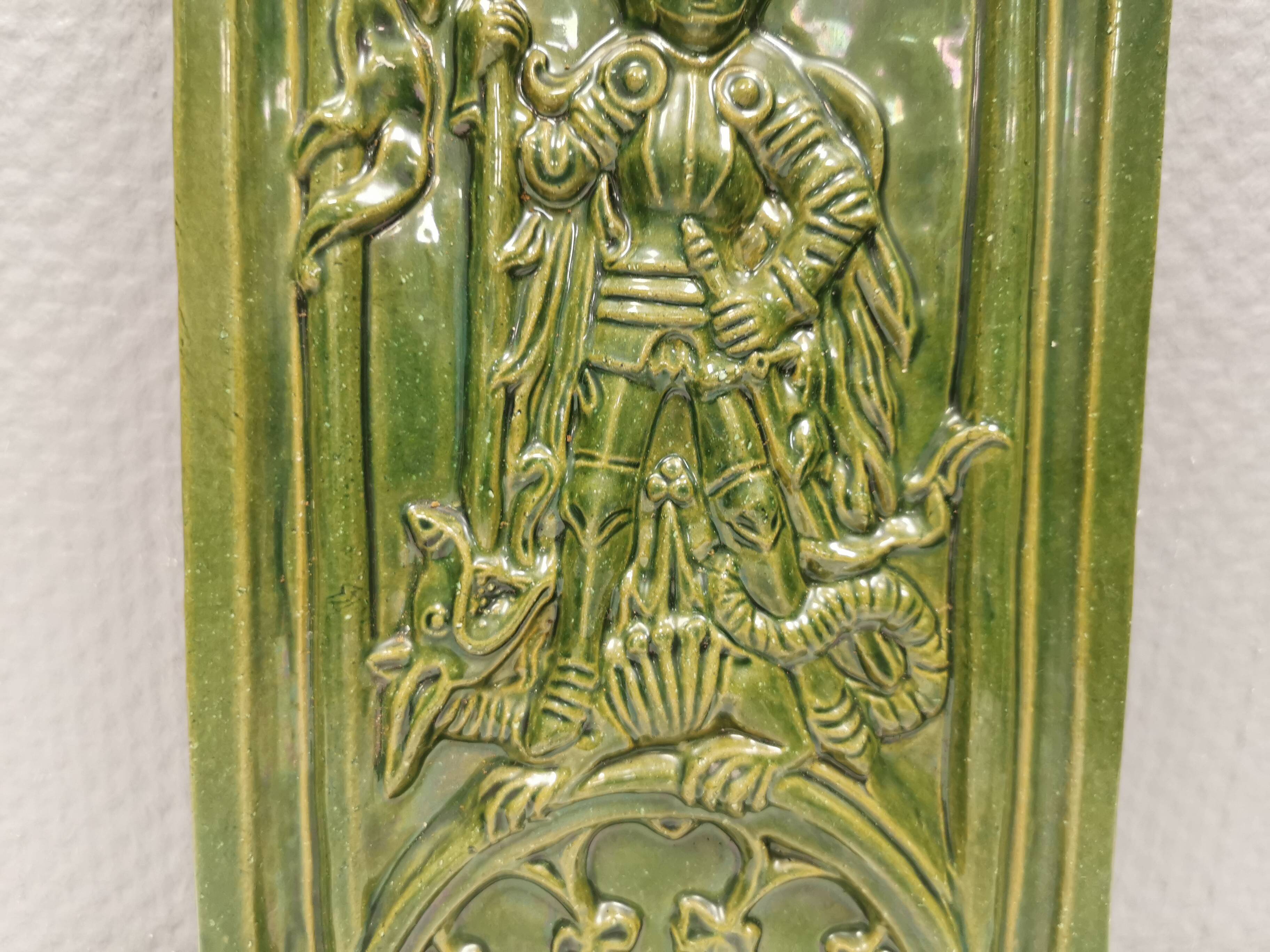 Antique tile in green faience, motif of Saint George and the dragon