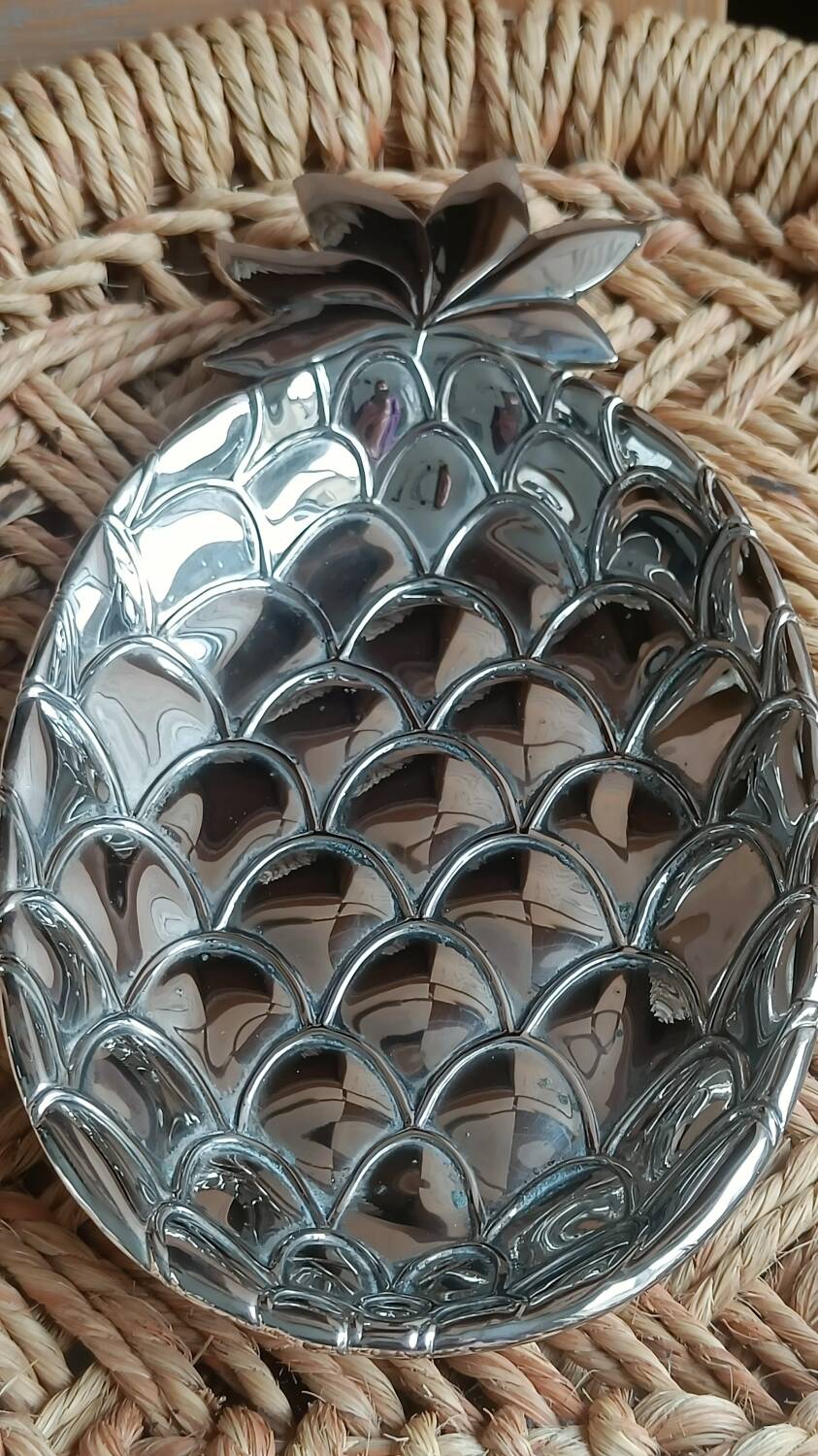 Silver-plated metal tray in the shape of a pineapple.