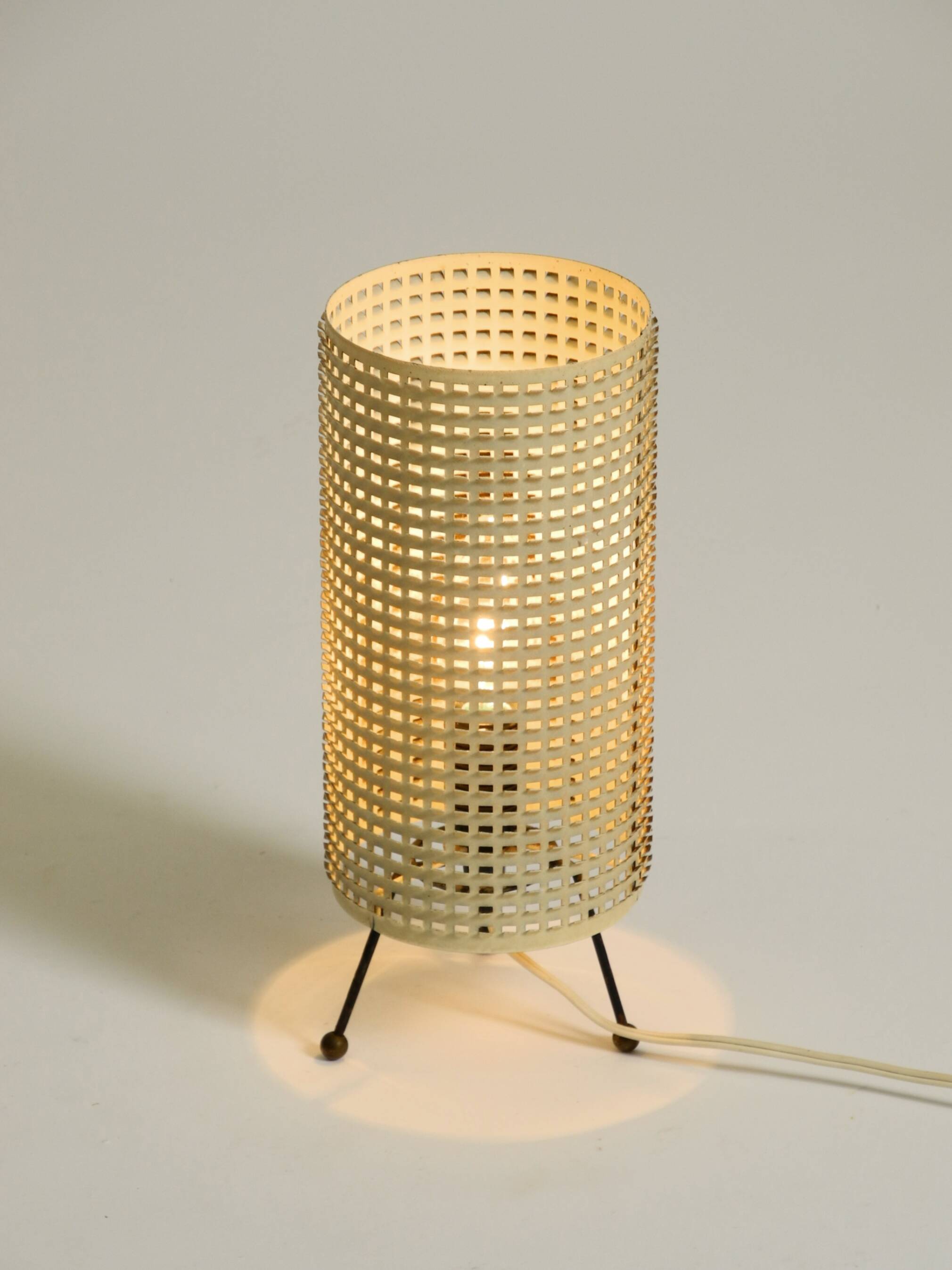 Original 1950s brass tripod table lamp with a perforated metal lampshade
