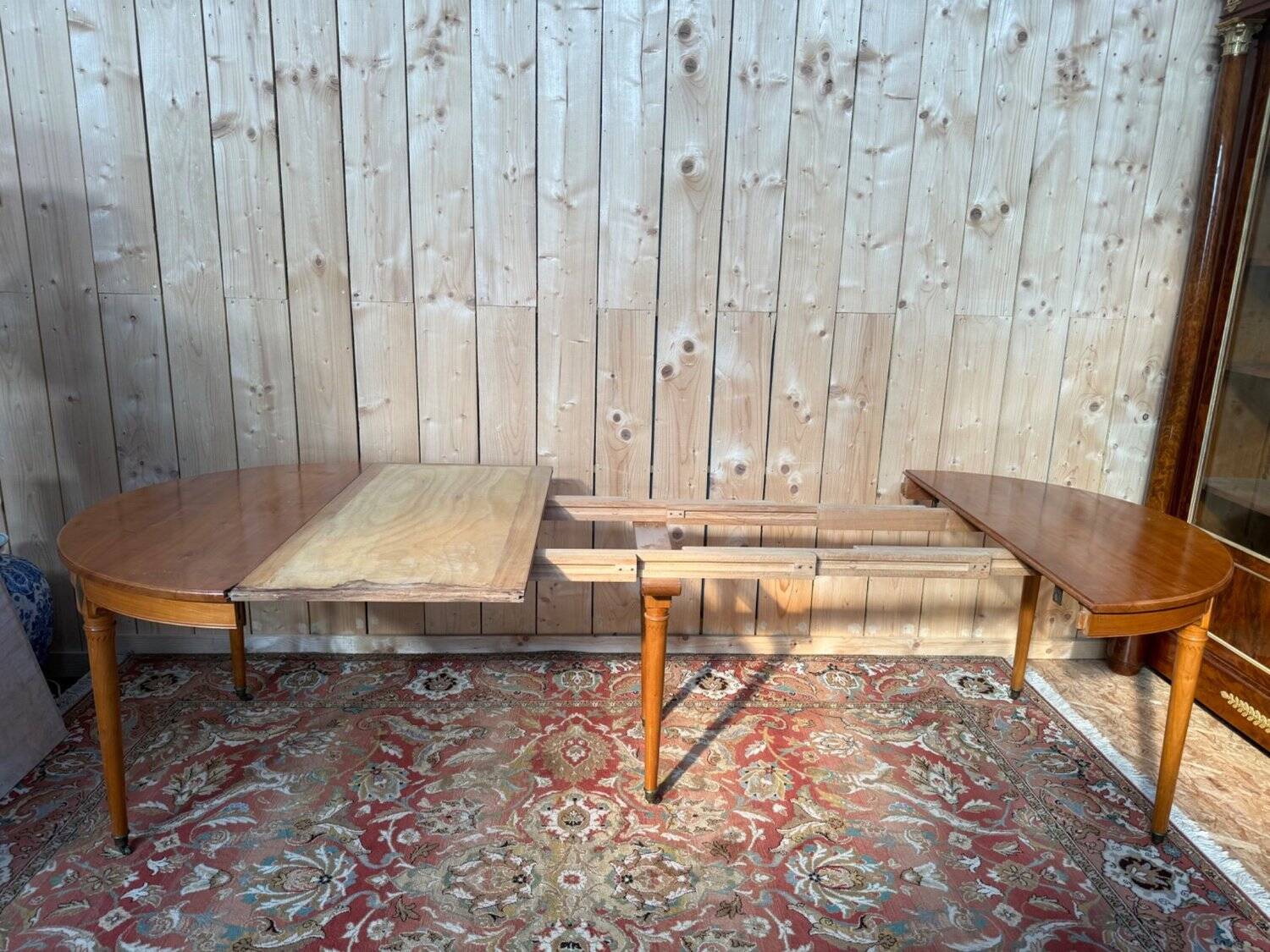 Louis XVI style dining table in cherry wood with extension.