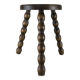 Small three-legged wooden stool with beaded feet.