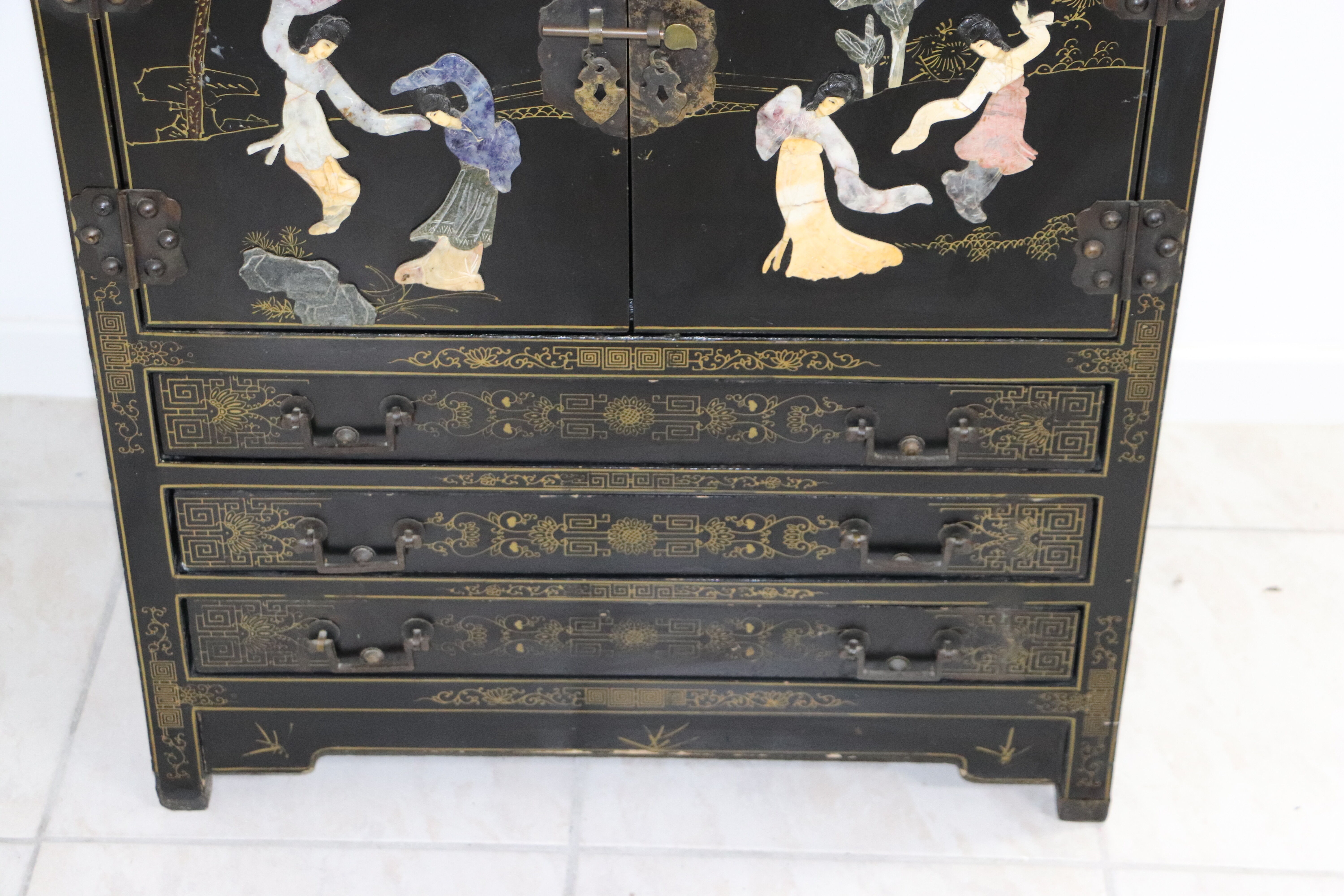 Black lacquered Chinese buffet with stone and ivory figures