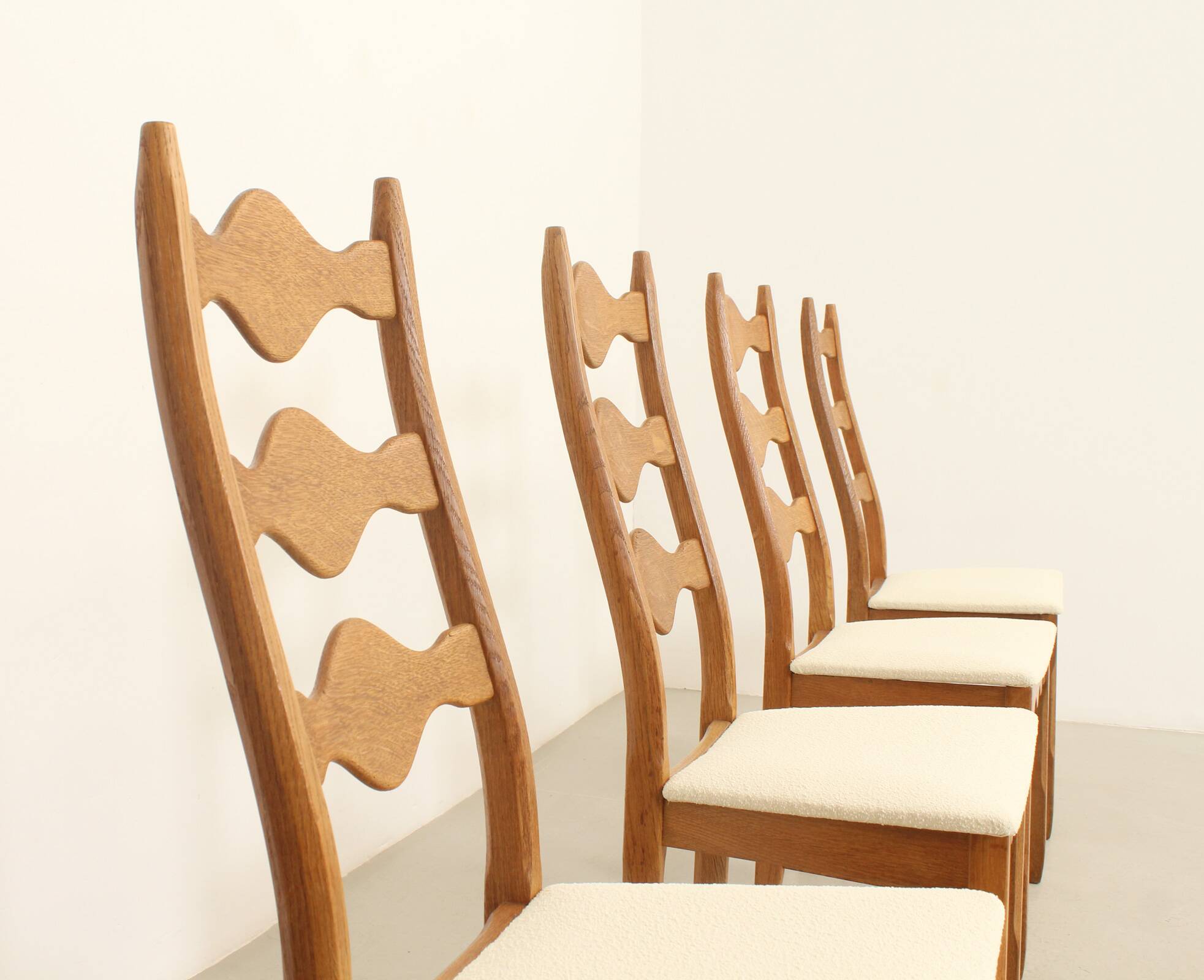 Four oak dining chairs by Henning Kjaernulf.