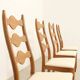 Four oak dining chairs by Henning Kjaernulf.