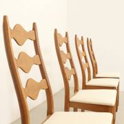 Four oak dining chairs by Henning Kjaernulf.