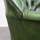 Large Chesterfield office armchair in green cowhide, in English style, on wheels.