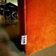Burnt orange modular sofa for four with a futuristic design.