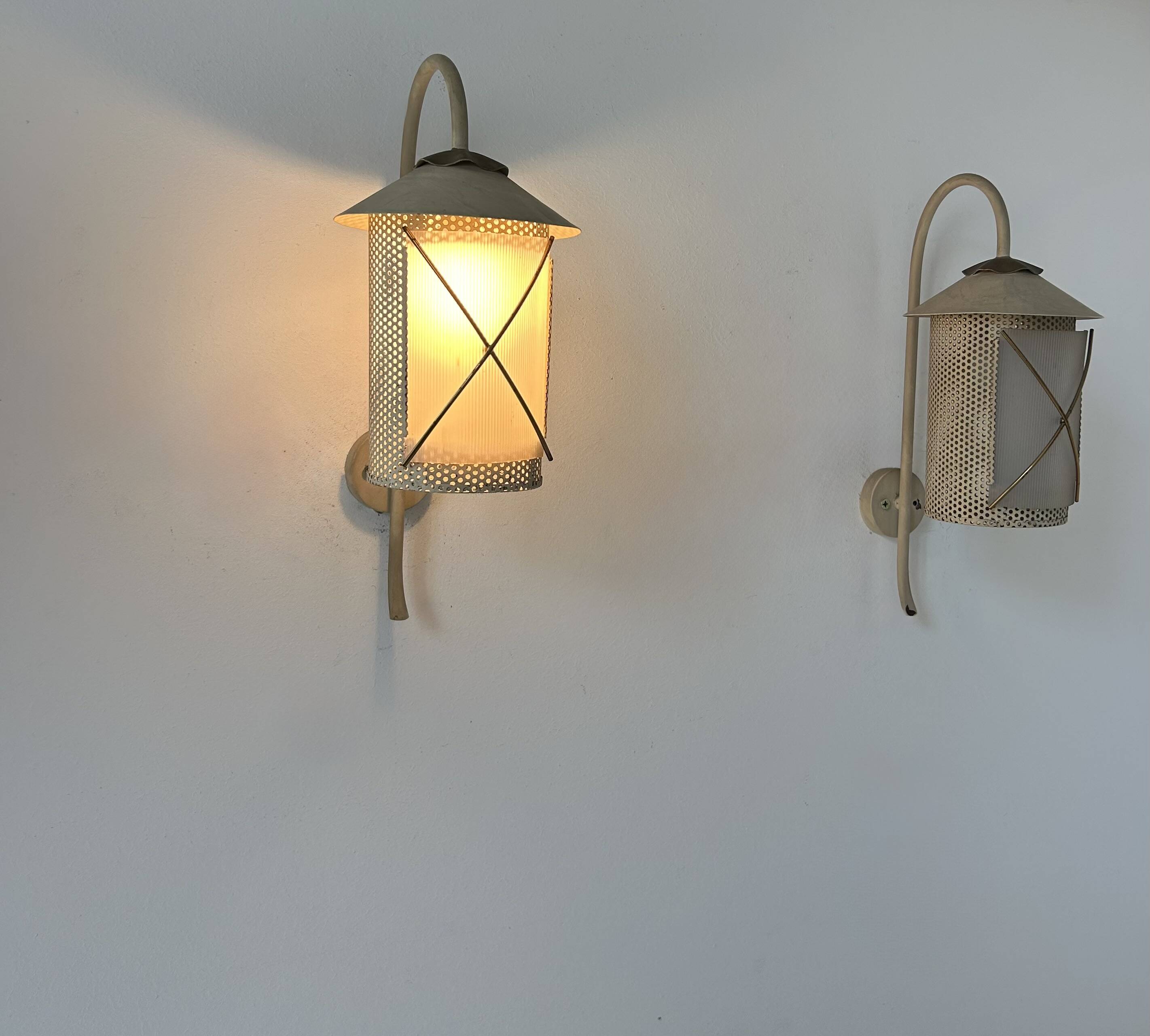 Pair of vintage wall lights in perforated metal, brass, and perspex, France, 1950.