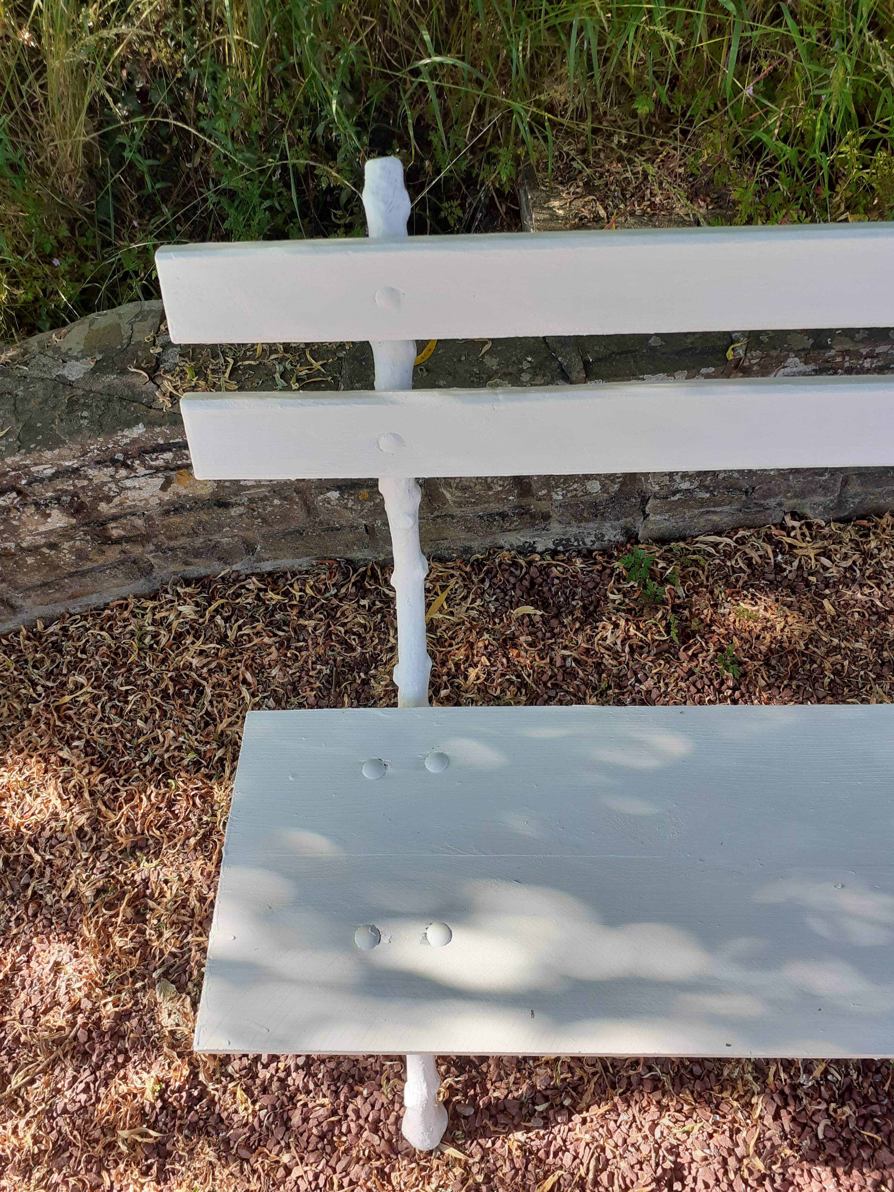 Old garden bench with cast iron feet and wooden planks