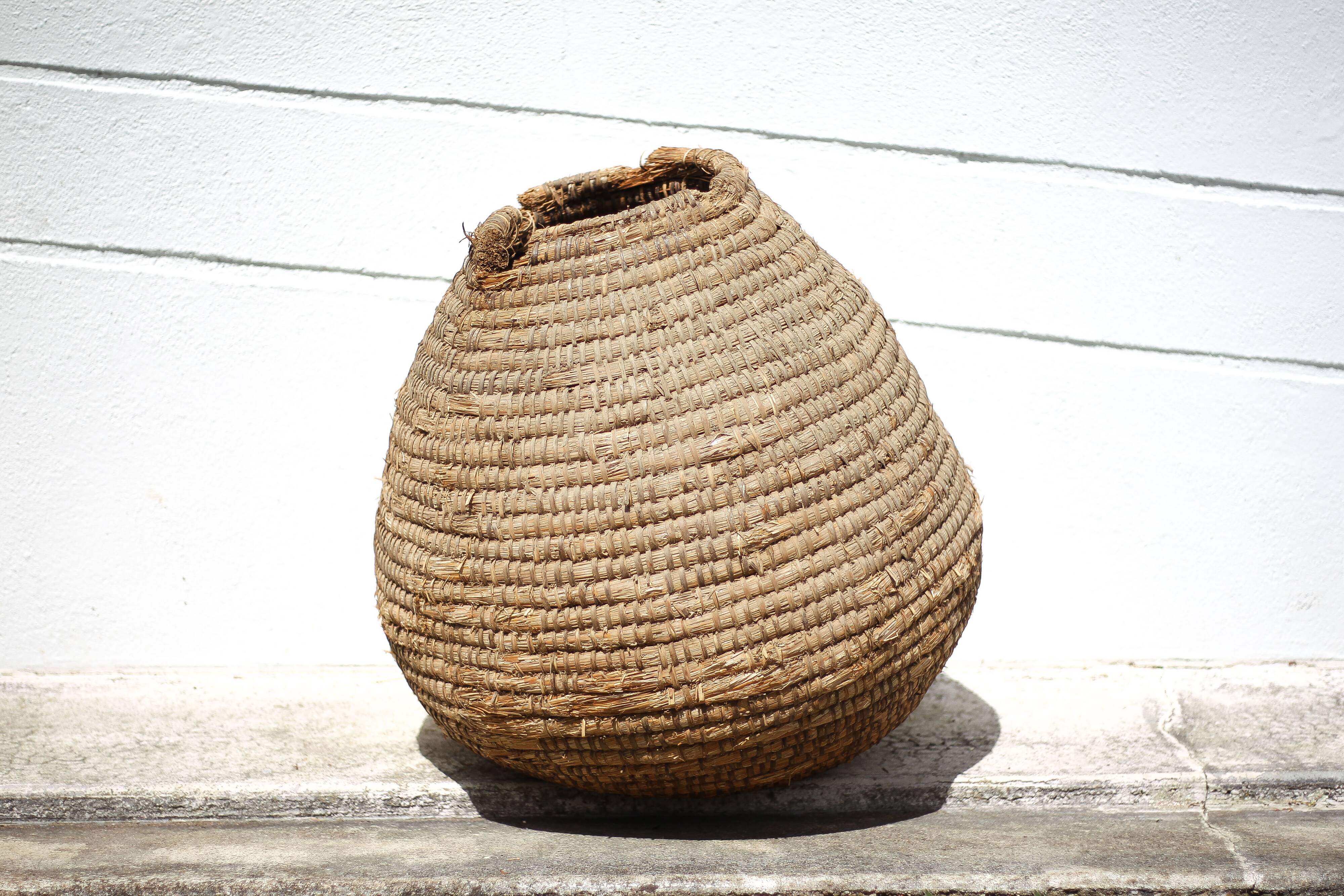 Old basket, burgundy straw and bramble, woven basket, interior decoration, pantry, flowerpot