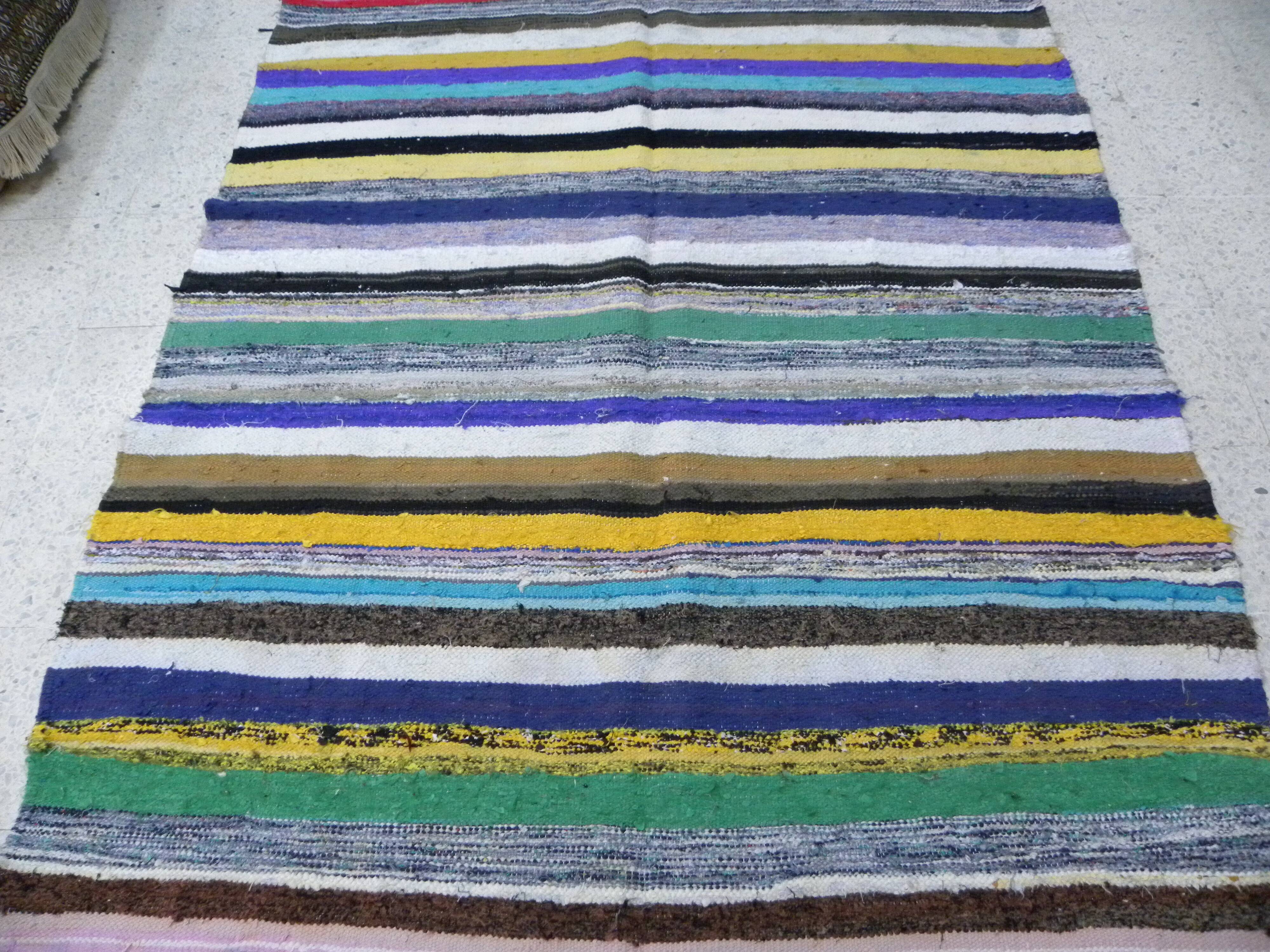 Vintage traditional nomadic kilim ethnic rug with multicoloured stripes.