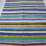 Vintage traditional nomadic kilim ethnic rug with multicoloured stripes.