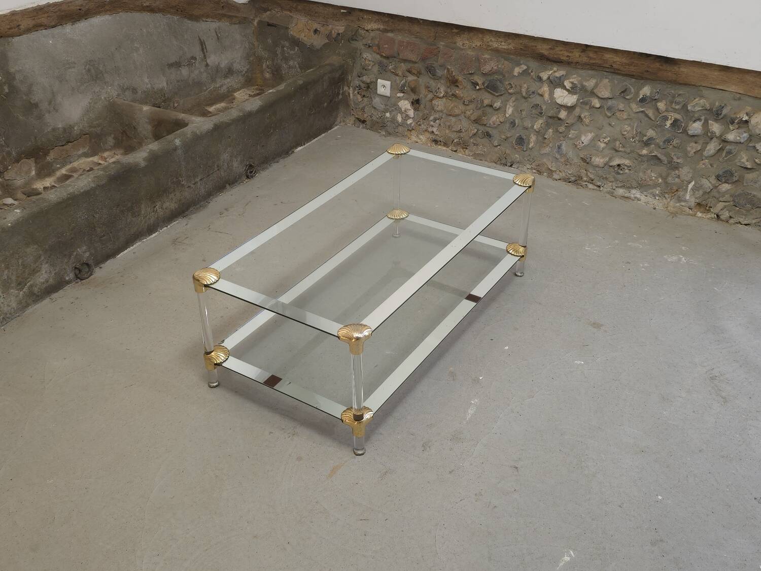Coffee table, living room table in glass with two tiers, adorned with golden seashells, 1970.