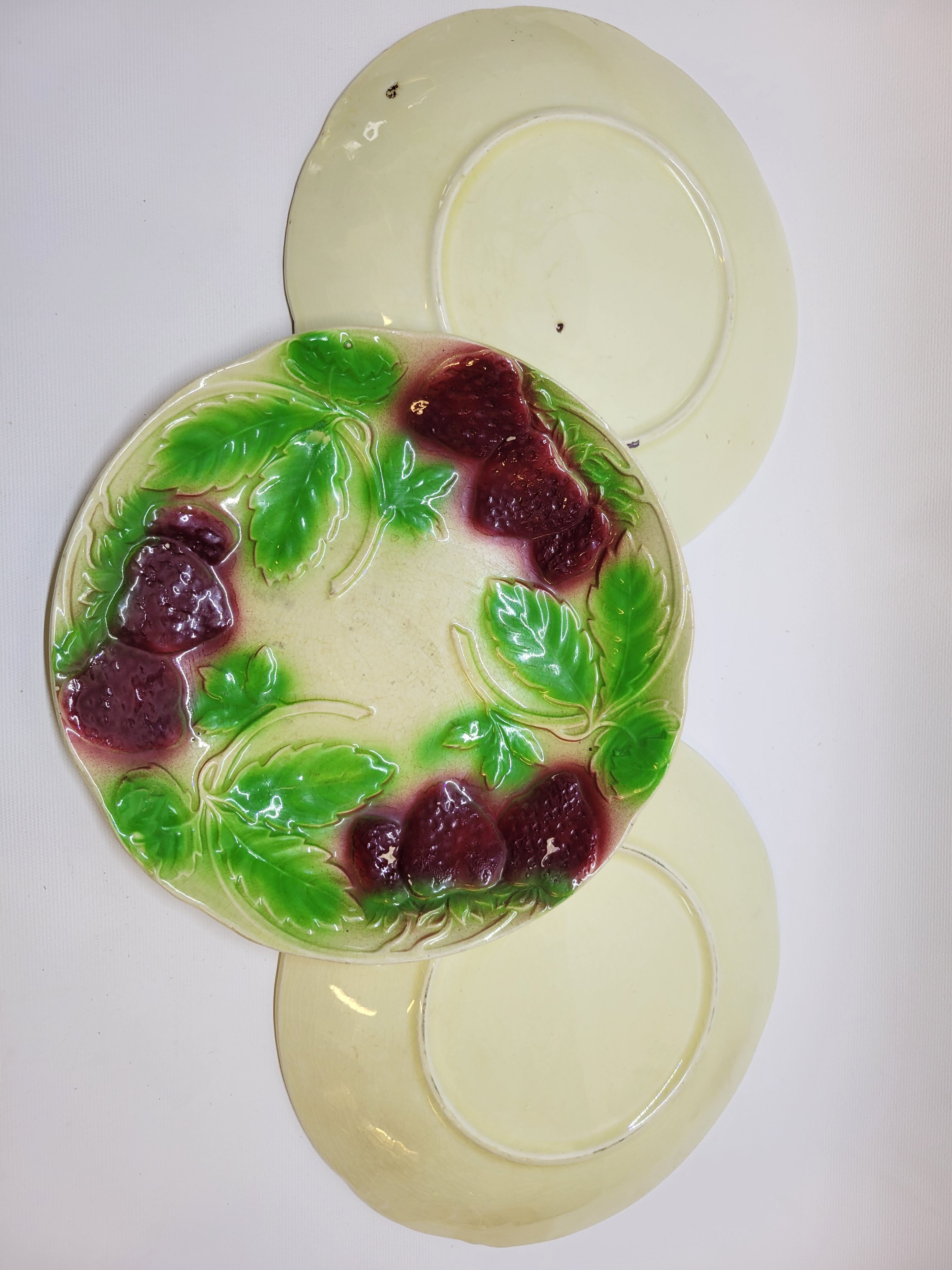 3 old plates in slip decoration strawberries and grapes