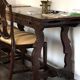 19th-century brown walnut dining table with sculpted trestle legs.
