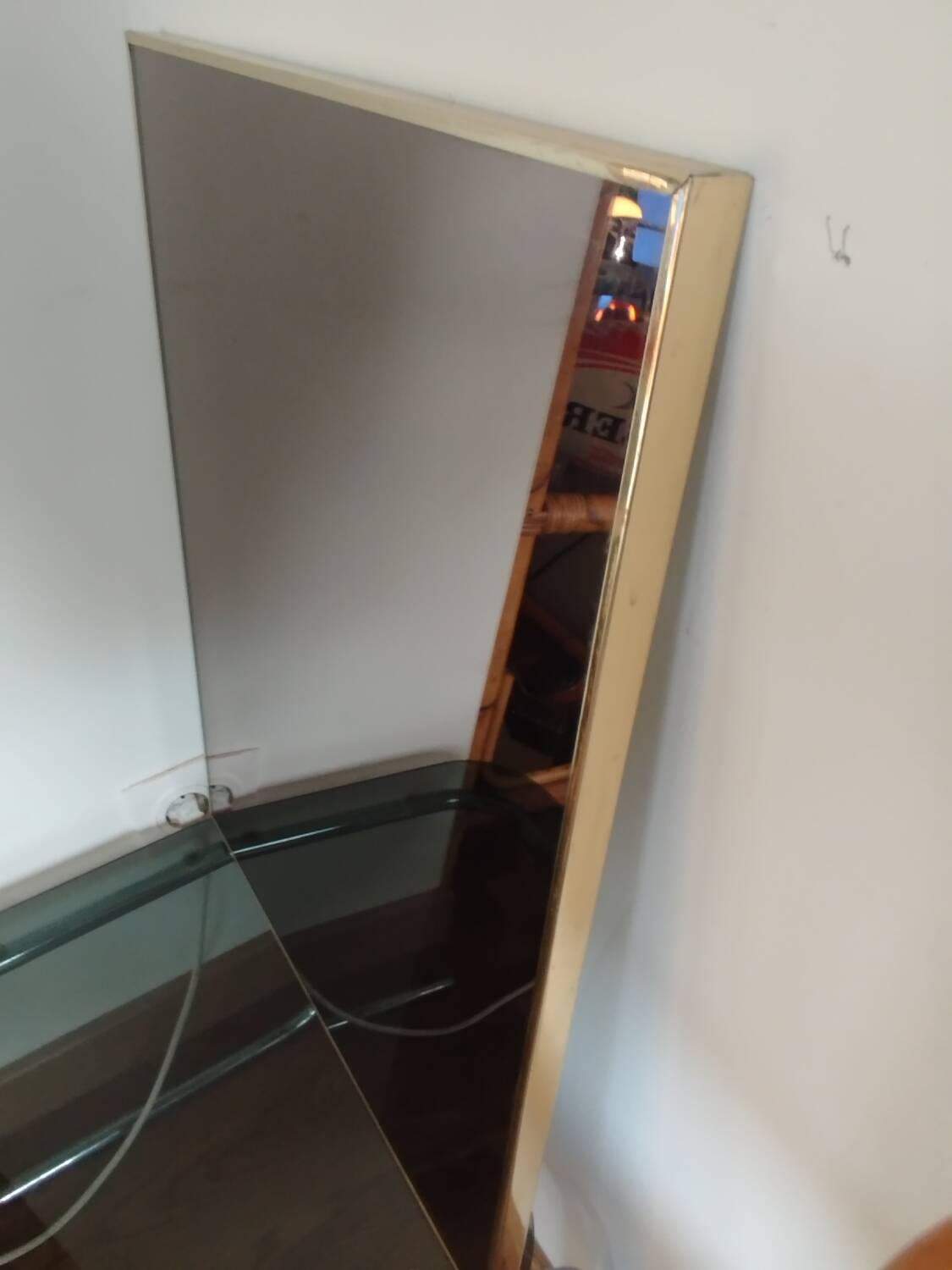 Vintage mirror in gilded brass and smoked glass. circa 1970