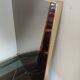 Vintage mirror in gilded brass and smoked glass. circa 1970