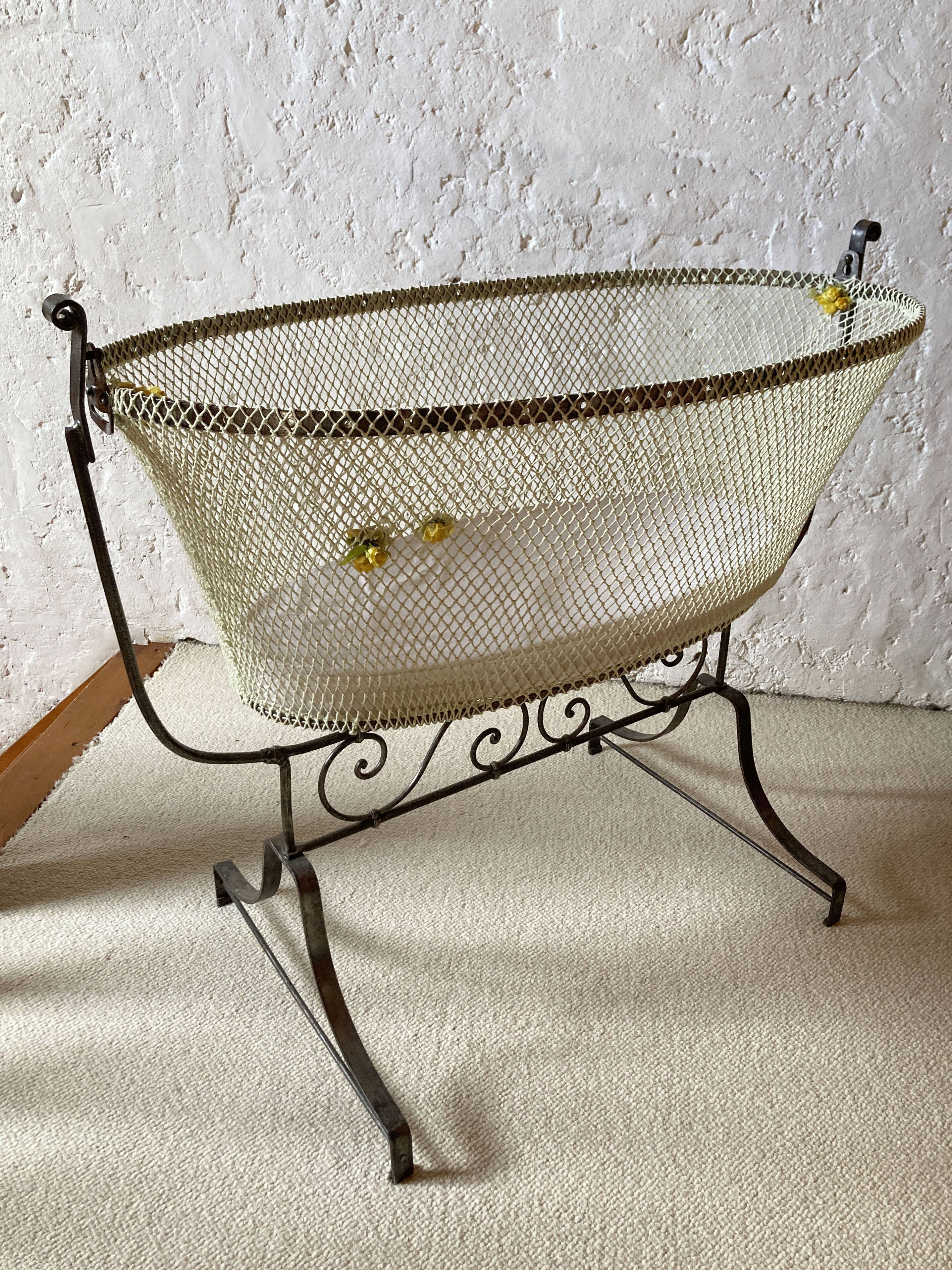 Antique rocking cradle in wrought iron