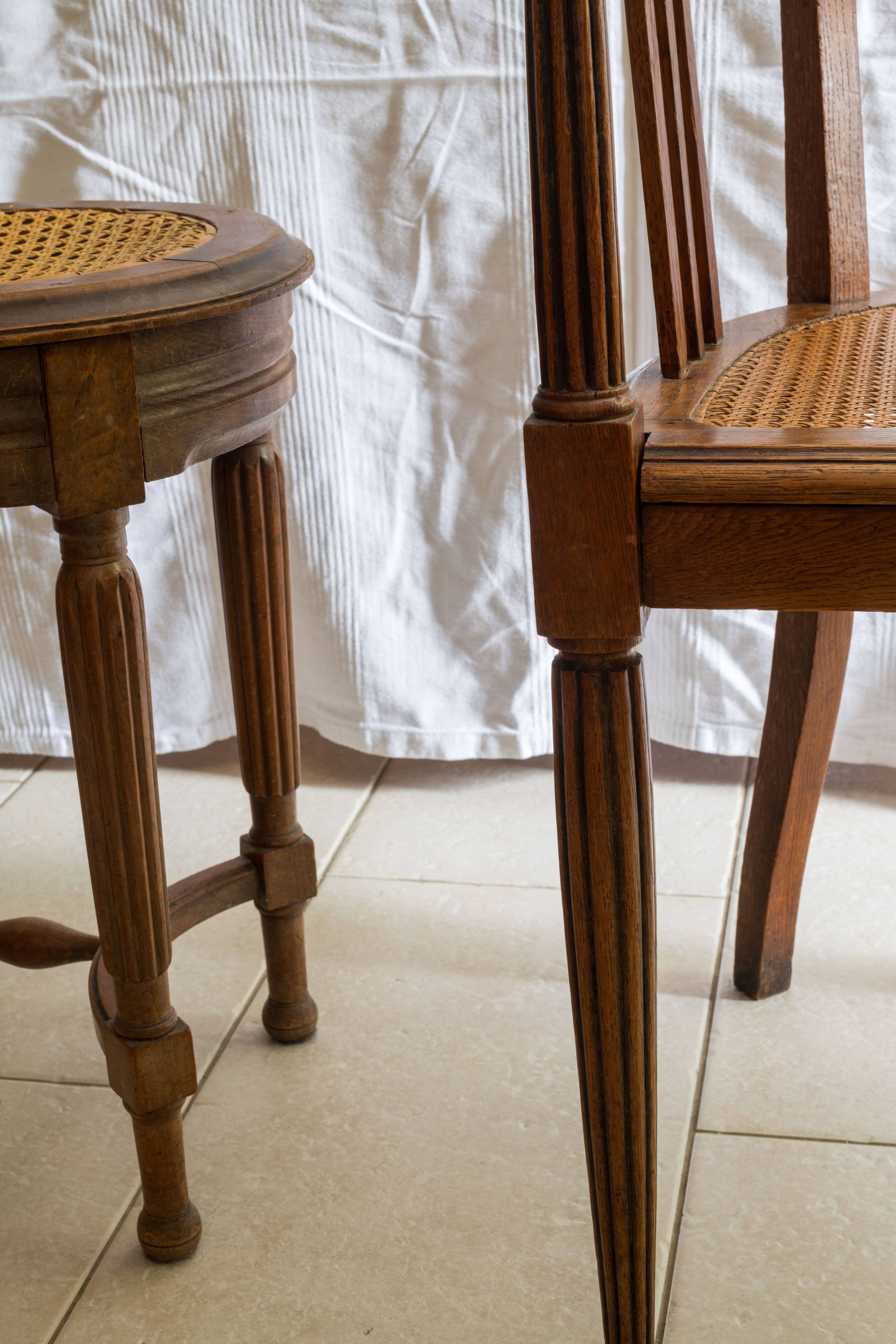 Antique armchair and stool with caned seat and fluted legs