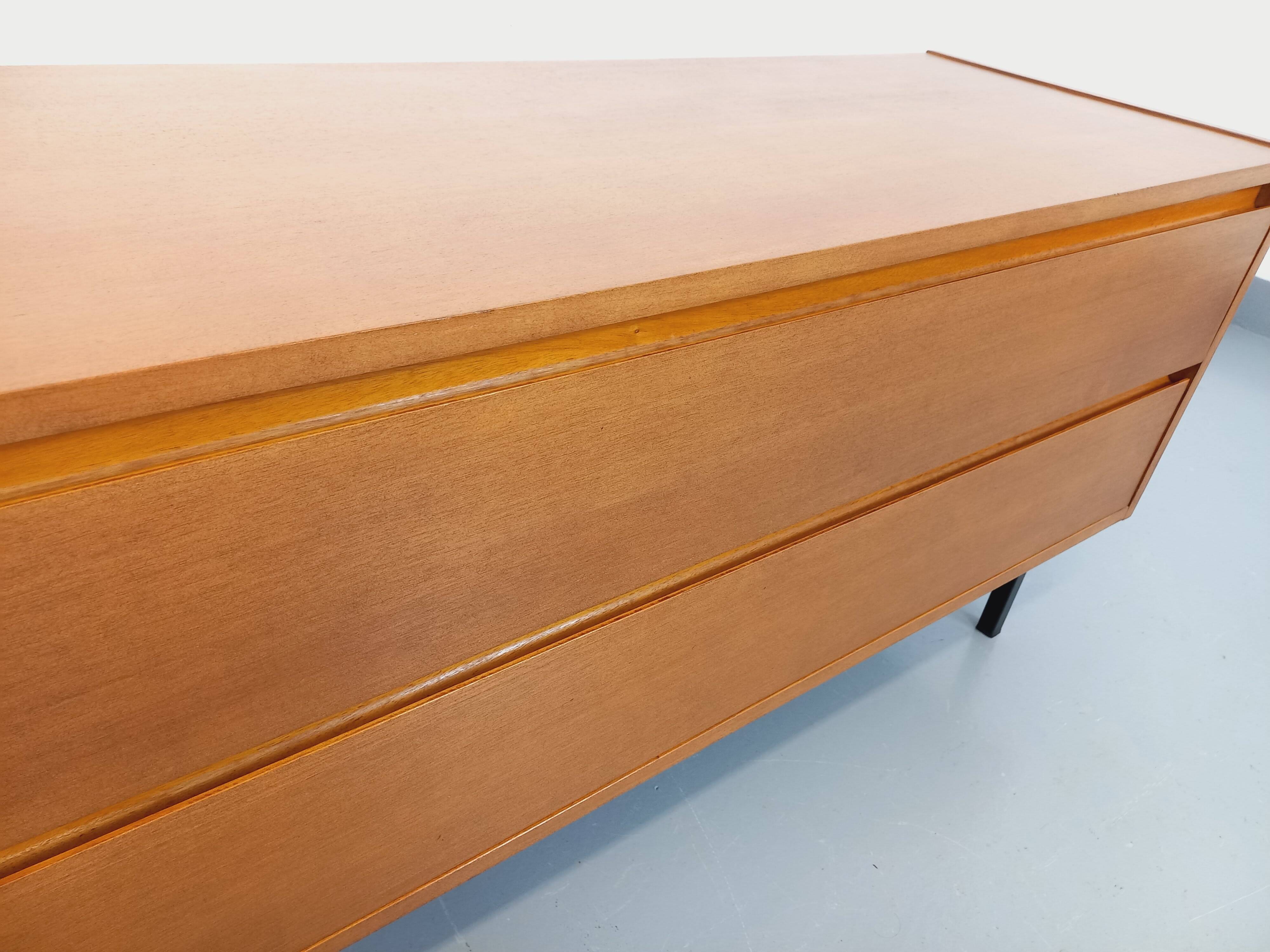 Small vintage Scandinavian sideboard in modernist style made of light oak wood.