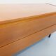 Small vintage Scandinavian sideboard in modernist style made of light oak wood.
