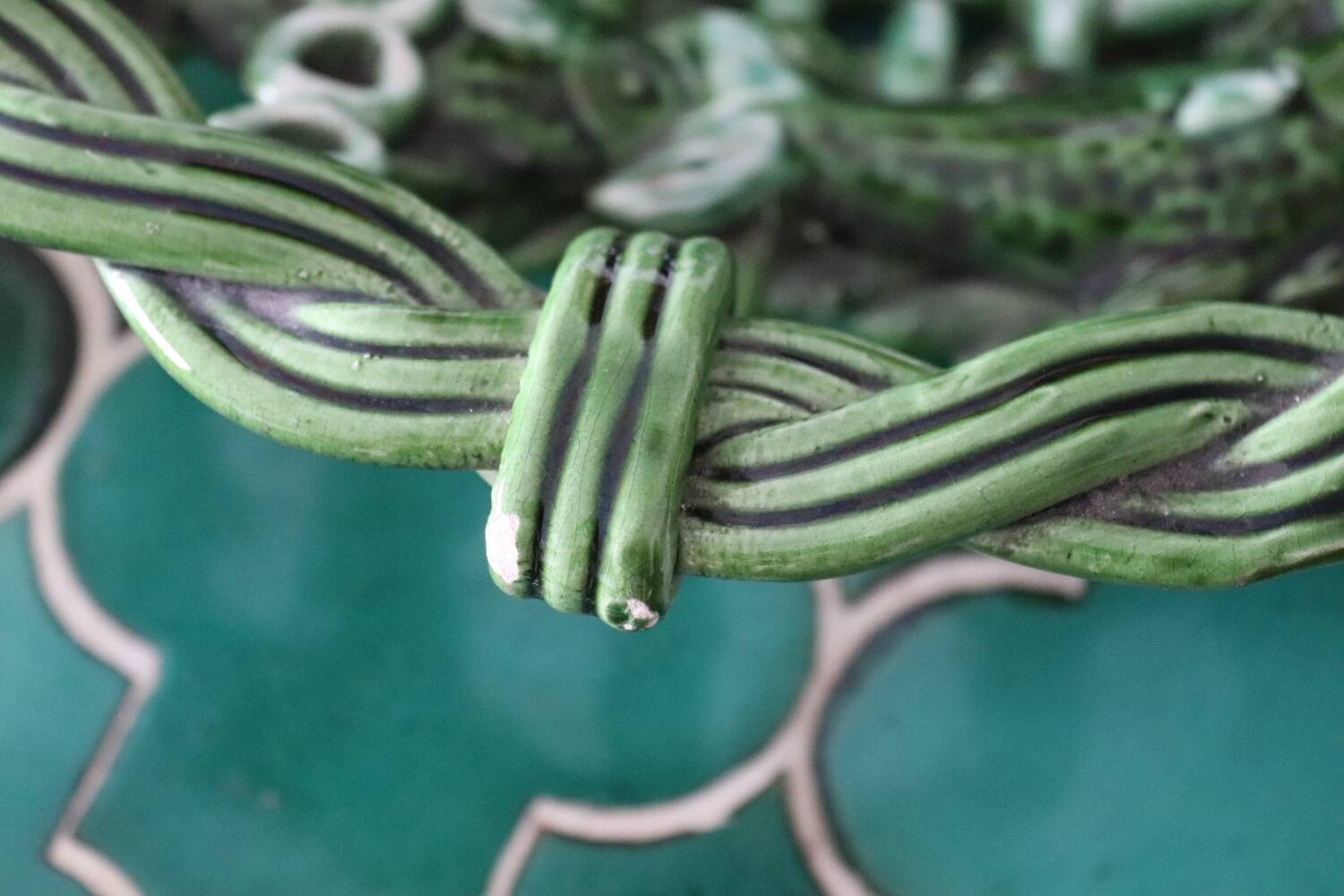 Antique woven basket in green glazed ceramic, fish decoration