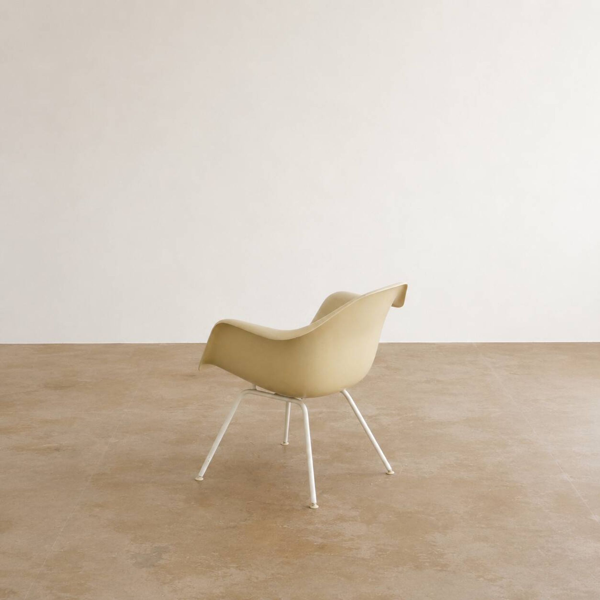Eames fiberglass armchair by herman miller with white lax base