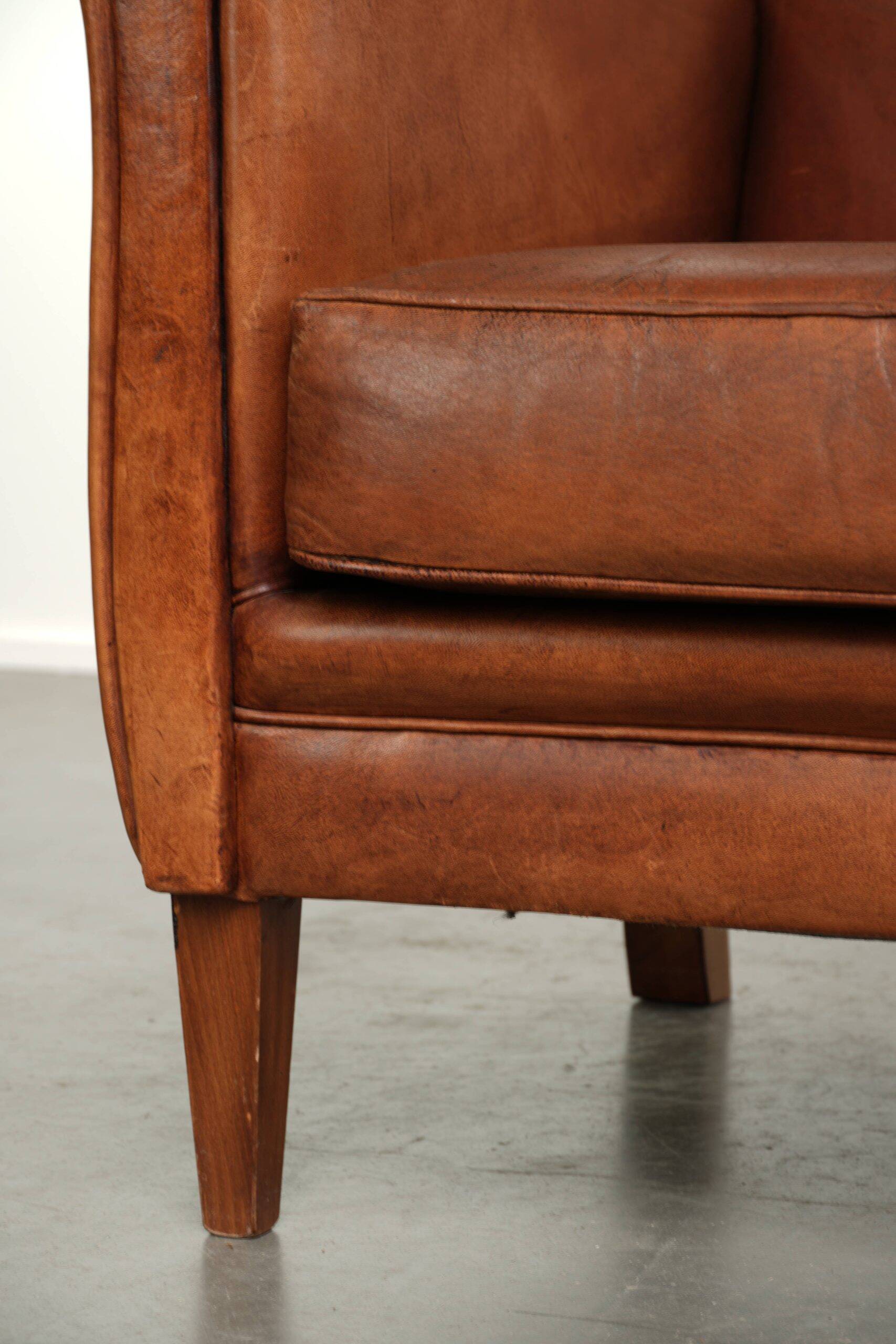 Sturdy vintage sheepskin armchair with a beautiful cognac colour