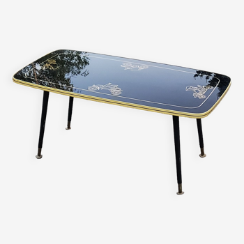 Table basse des années 60 en verre noir et doré pieds compas en bois noirci et laiton
