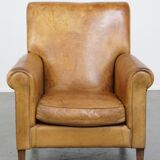 Stylish patinated vintage sheepskin armchair with a comfortable seat